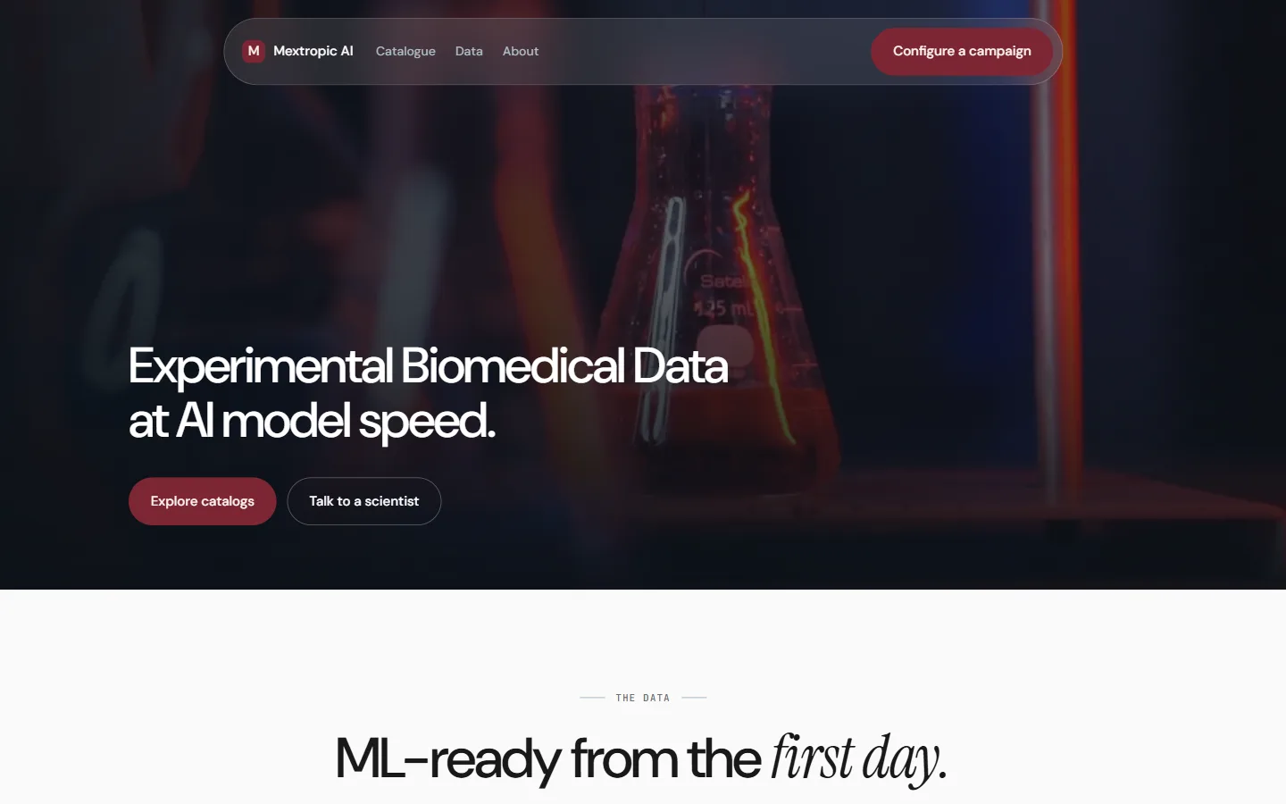 The Mextropic AI homepage: a dark hero reading "Experimental Biomedical Data at AI model speed" over a laboratory flask.